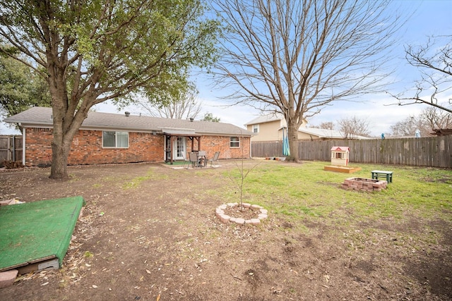 view of yard with a patio area, a fenced backyard, and a fire pit