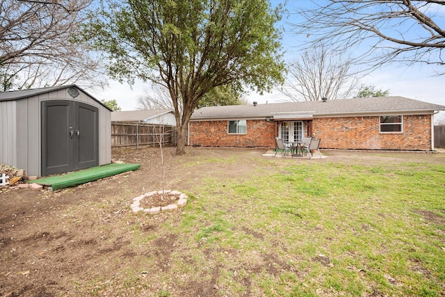 back of house with a patio, fence private yard, an outdoor structure, a lawn, and a shed