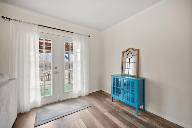 entryway with french doors, crown molding, baseboards, and wood finished floors