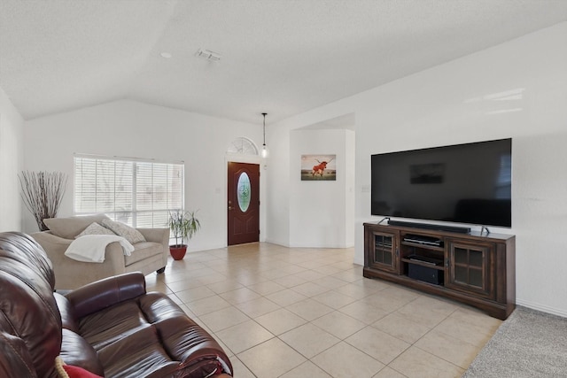 living area featuring lofted ceiling, light tile patterned floors, visible vents, and baseboards