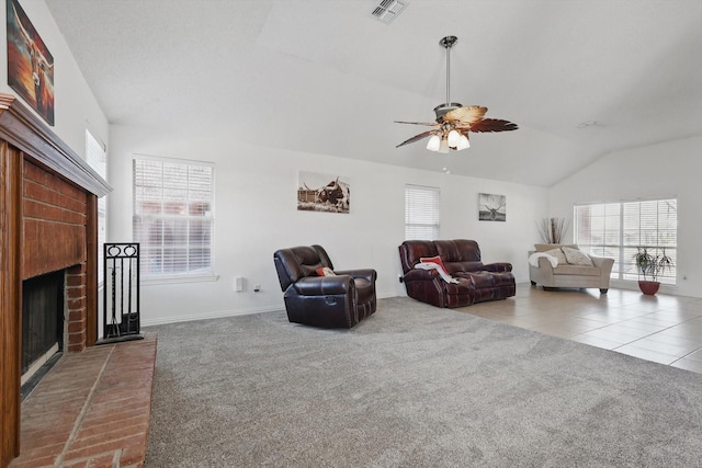 carpeted living area featuring visible vents, a ceiling fan, lofted ceiling, tile patterned floors, and a brick fireplace