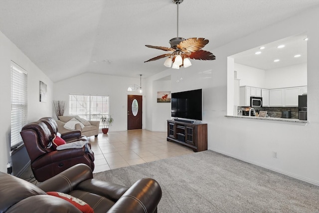 living area featuring light tile patterned floors, lofted ceiling, recessed lighting, light colored carpet, and a ceiling fan