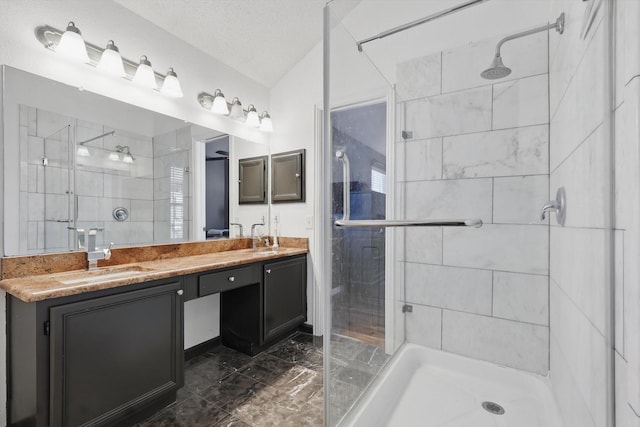 full bathroom with a sink, a shower stall, and double vanity