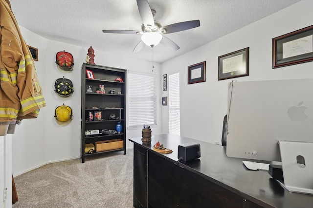 office with a ceiling fan, a textured ceiling, and light colored carpet