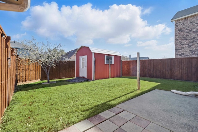 view of yard with an outbuilding, a patio, a storage unit, and a fenced backyard