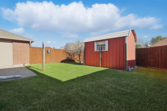 view of yard featuring an outbuilding, a patio area, a fenced backyard, and a storage unit