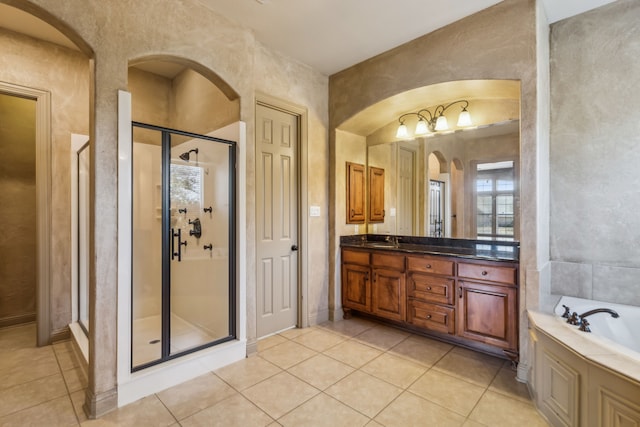 full bath featuring a bath, a shower stall, vanity, and tile patterned floors