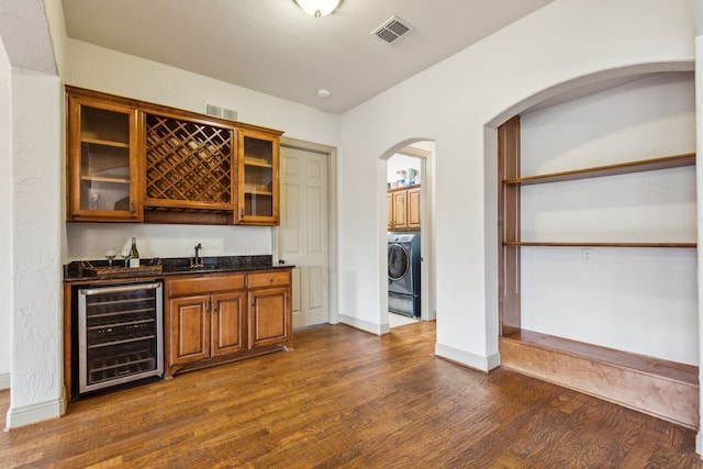 5805 Parker Village Dr, Parker, TX 75002 - indoor wet bar with wine cooler, dark wood finished floors, baseboards, and washer / dryer