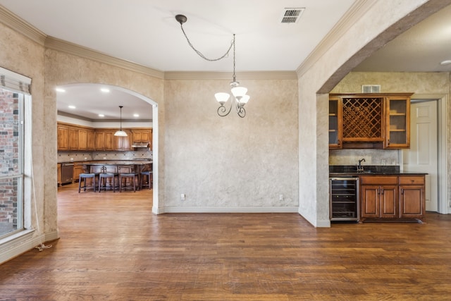 bar featuring beverage cooler, a sink, visible vents, stainless steel dishwasher, and dark wood finished floors