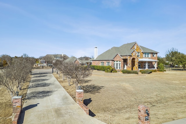 view of front of home featuring stone siding and a chimney