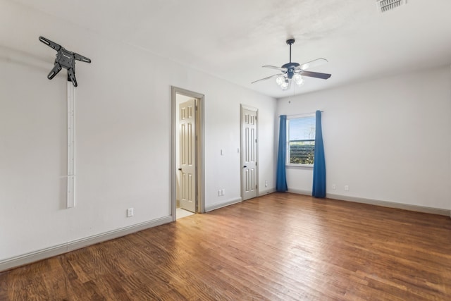 unfurnished bedroom with visible vents, baseboards, ceiling fan, and wood finished floors