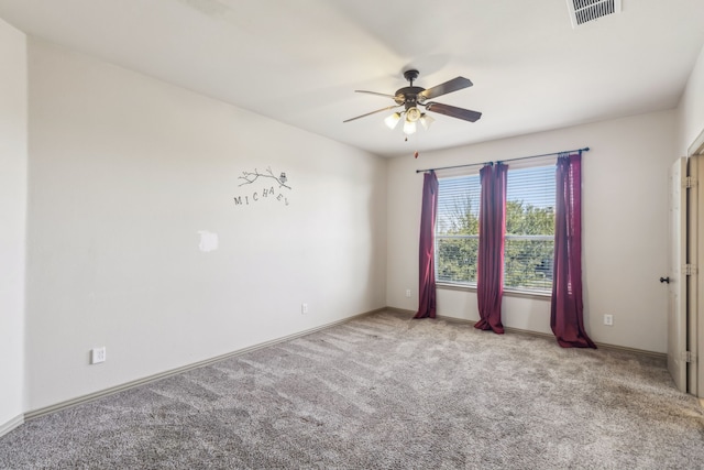 unfurnished room featuring ceiling fan, carpet floors, visible vents, and baseboards