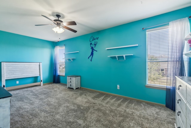 interior space featuring ceiling fan, baseboards, and carpet flooring