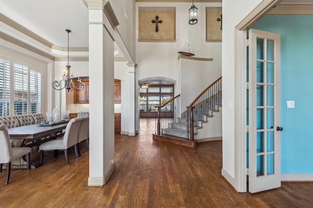 interior space featuring a wealth of natural light, wood finished floors, arched walkways, and stairs