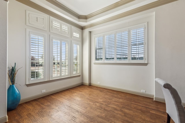 interior space with crown molding, baseboards, and wood finished floors