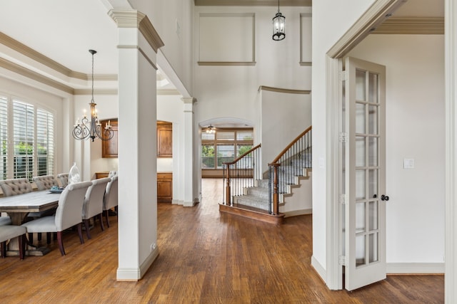 5805 Parker Village Dr, Parker, TX 75002 - foyer with dark wood finished floors, decorative columns, stairs, a chandelier, and baseboards
