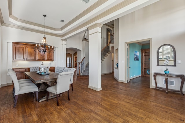 dining area featuring arched walkways, a raised ceiling, visible vents, stairway, and wood finished floors