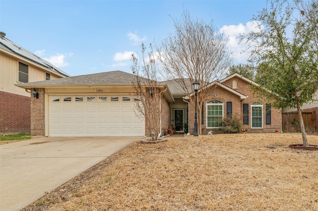 ranch-style house featuring a garage, concrete driveway, brick siding, and fence