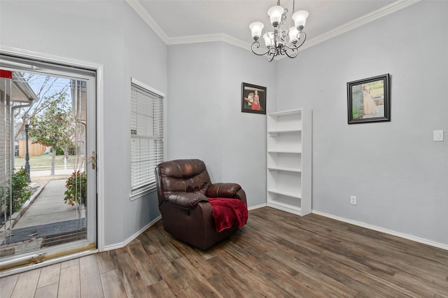 sitting room with a notable chandelier, crown molding, baseboards, and wood finished floors