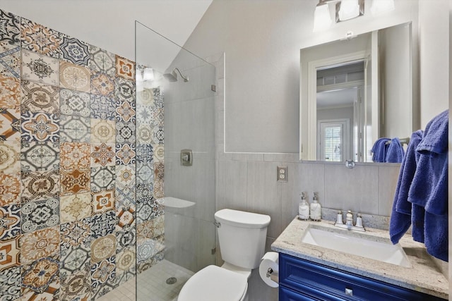 full bath with a stall shower, toilet, lofted ceiling, a wainscoted wall, and vanity