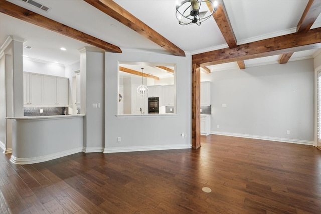 unfurnished living room featuring dark wood-style flooring, visible vents, a notable chandelier, and baseboards