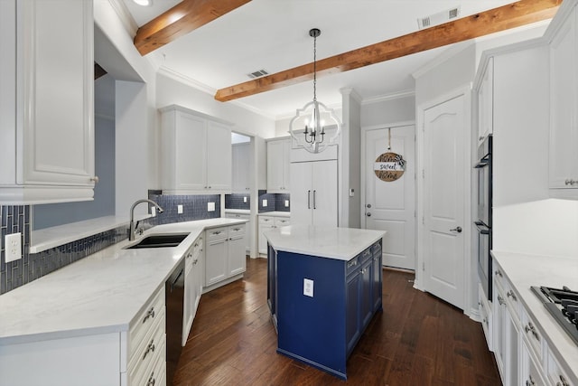 kitchen with blue cabinets, a sink, appliances with stainless steel finishes, tasteful backsplash, and beamed ceiling