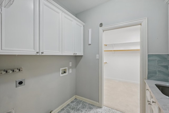 clothes washing area with washer hookup, a sink, baseboards, cabinet space, and electric dryer hookup