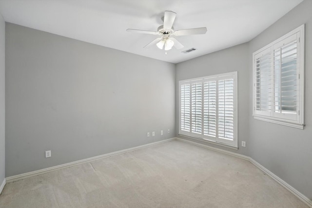 unfurnished room featuring baseboards, ceiling fan, visible vents, and carpet flooring