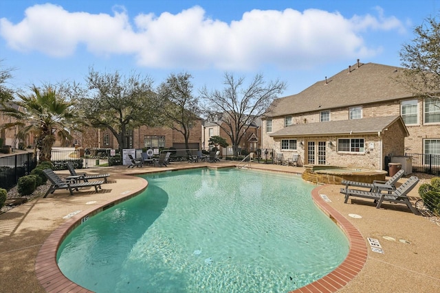 pool with fence and a patio