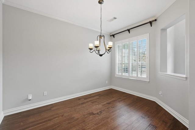 unfurnished room with crown molding, dark wood finished floors, a notable chandelier, visible vents, and baseboards