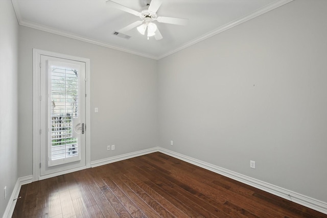 spare room with baseboards, visible vents, a ceiling fan, dark wood-style floors, and ornamental molding