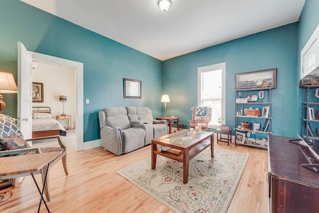 living room with light wood-type flooring and baseboards