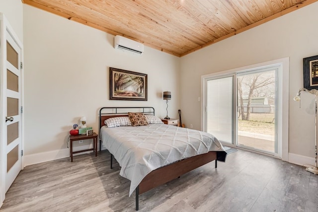 bedroom with baseboards, light wood finished floors, a wall mounted AC, wood ceiling, and access to outside