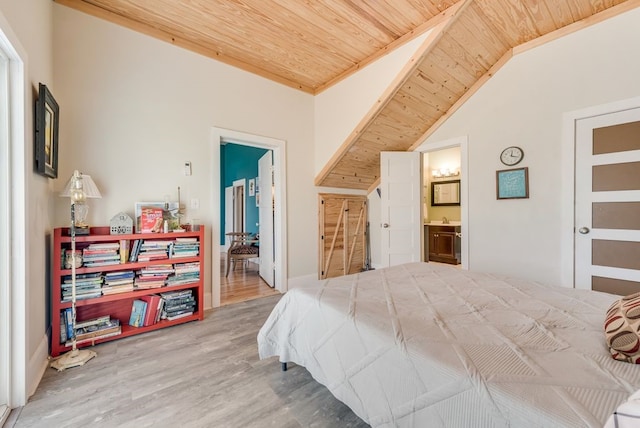 bedroom featuring connected bathroom, wood finished floors, lofted ceiling, and wooden ceiling