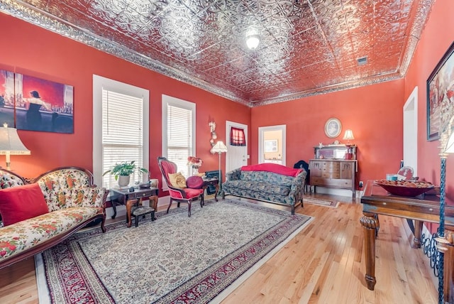 bedroom featuring hardwood / wood-style flooring, visible vents, an ornate ceiling, and ornamental molding