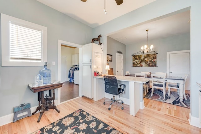 office area featuring ceiling fan with notable chandelier, baseboards, and light wood finished floors