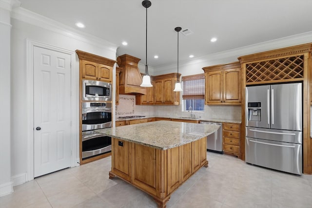 kitchen with a kitchen island, premium range hood, ornamental molding, light stone counters, and appliances with stainless steel finishes