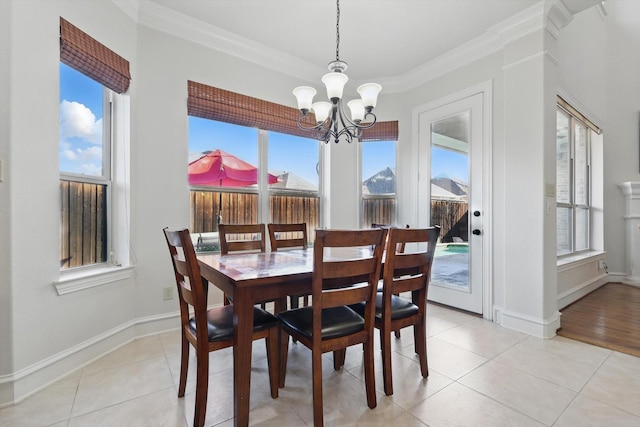 dining space with light tile patterned flooring, plenty of natural light, and crown molding