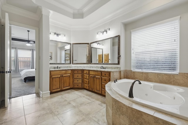 bathroom with a whirlpool tub, ensuite bath, crown molding, and a sink