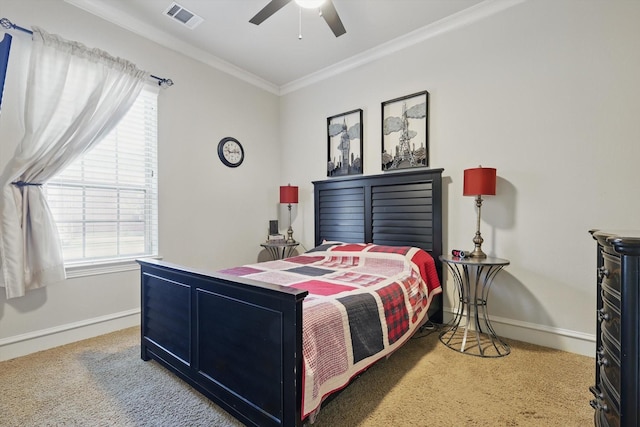 carpeted bedroom featuring crown molding, baseboards, visible vents, and ceiling fan