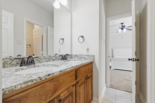 ensuite bathroom with a sink, double vanity, ensuite bathroom, and tile patterned flooring