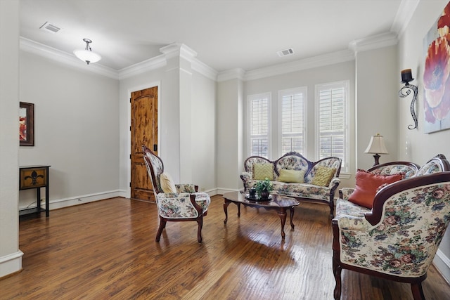 sitting room with visible vents, hardwood / wood-style floors, and ornamental molding