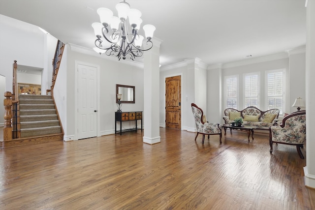 sitting room featuring stairway, baseboards, wood finished floors, and crown molding