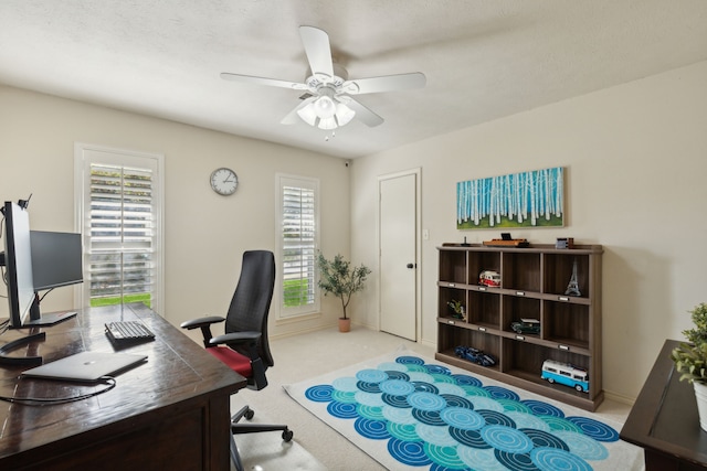 office space with carpet, baseboards, a wealth of natural light, and ceiling fan