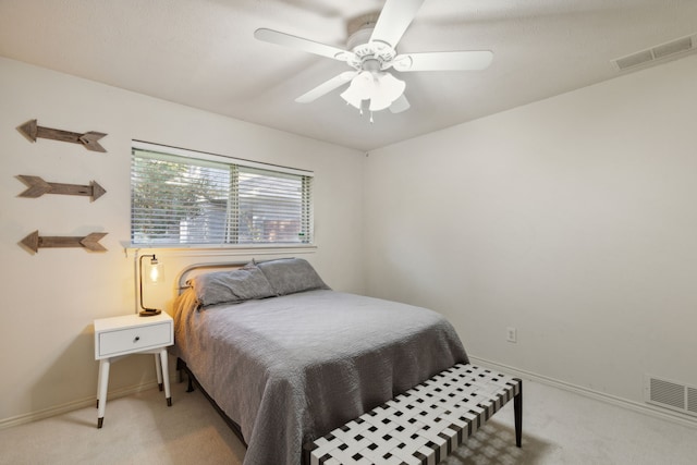bedroom with light carpet, visible vents, and baseboards