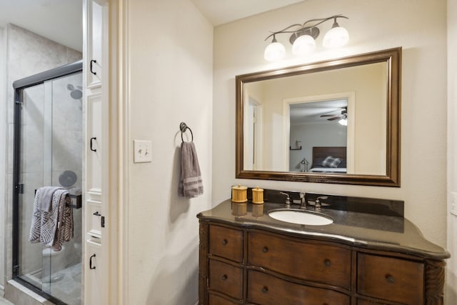 full bath with vanity, ceiling fan, and a stall shower