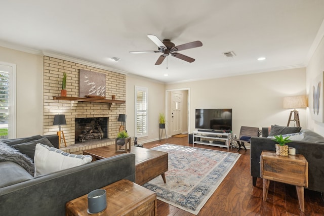 living area with visible vents, crown molding, a wealth of natural light, and ceiling fan