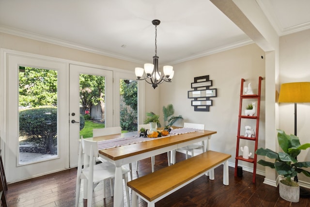 dining space featuring ornamental molding, a healthy amount of sunlight, a chandelier, and dark wood-style floors