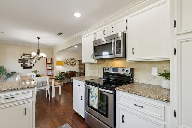 kitchen featuring white cabinets, decorative backsplash, an inviting chandelier, stainless steel appliances, and dark wood finished floors