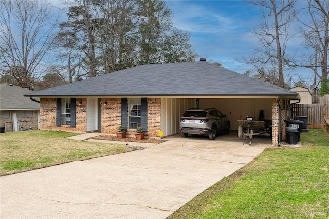 ranch-style house with driveway, brick siding, fence, and a front yard